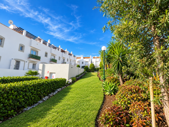 Jardín mediterráneo entre casas blancas
